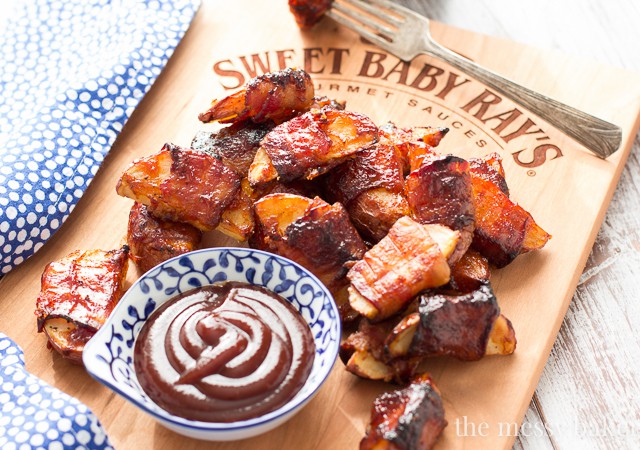 These crispy potato wedges wrapped in smoky bacon and glazed with barbecue sauce make the perfect appetizer for football, the holidays, and parties. | www.themessybakerblog.com