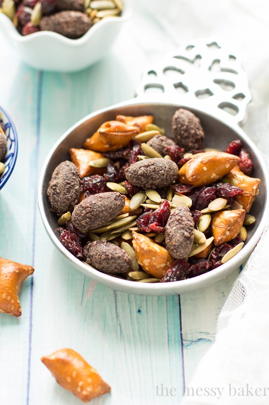 Easy Fall Trail Mix made with pumpkin seeds, dried cranberries, peanut butter filled pretzels, and dark chocolate covered almonds | www.themessybakerblog.com