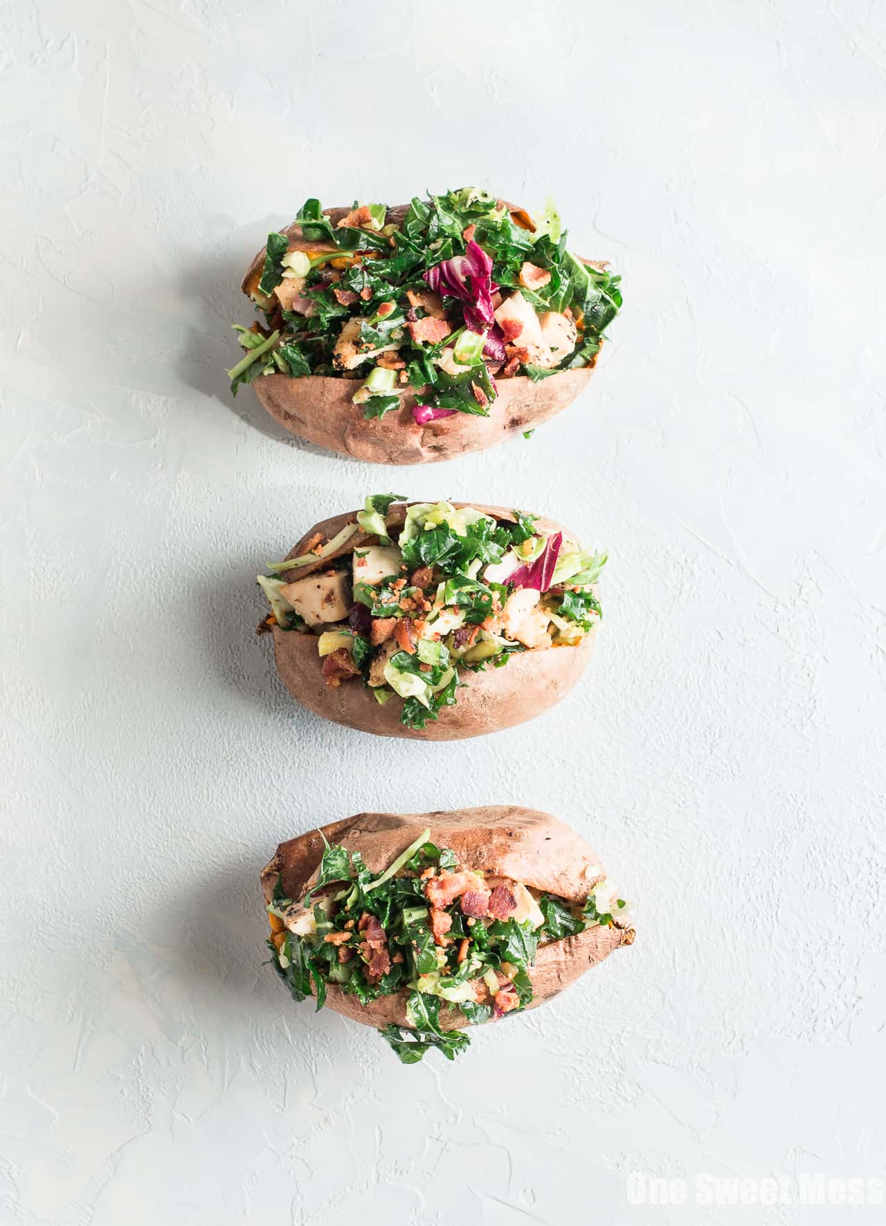Grilled Chicken & Sweet Kale Salad Stuffed Sweet Potatoes: Loaded with grilled poppy seed dressing glazed chicken and topped with sweet kale salad tossed in warm bacon vinaigrette. Hearty, healthy and gluten-free.