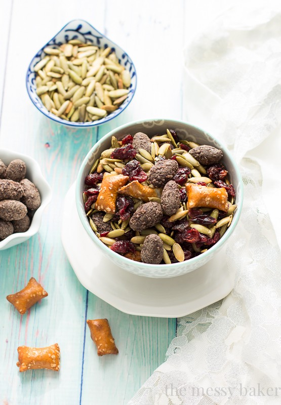 Easy Fall Trail Mix made with pumpkin seeds, dried cranberries, peanut butter filled pretzels, and dark chocolate covered almonds | www.themessybakerblog.com
