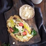 Gluten-Free Greek Salad Naan Pizza: Gluten-Free Naan smeared with creamy hummus and topped with a mound of fresh Greek salad.